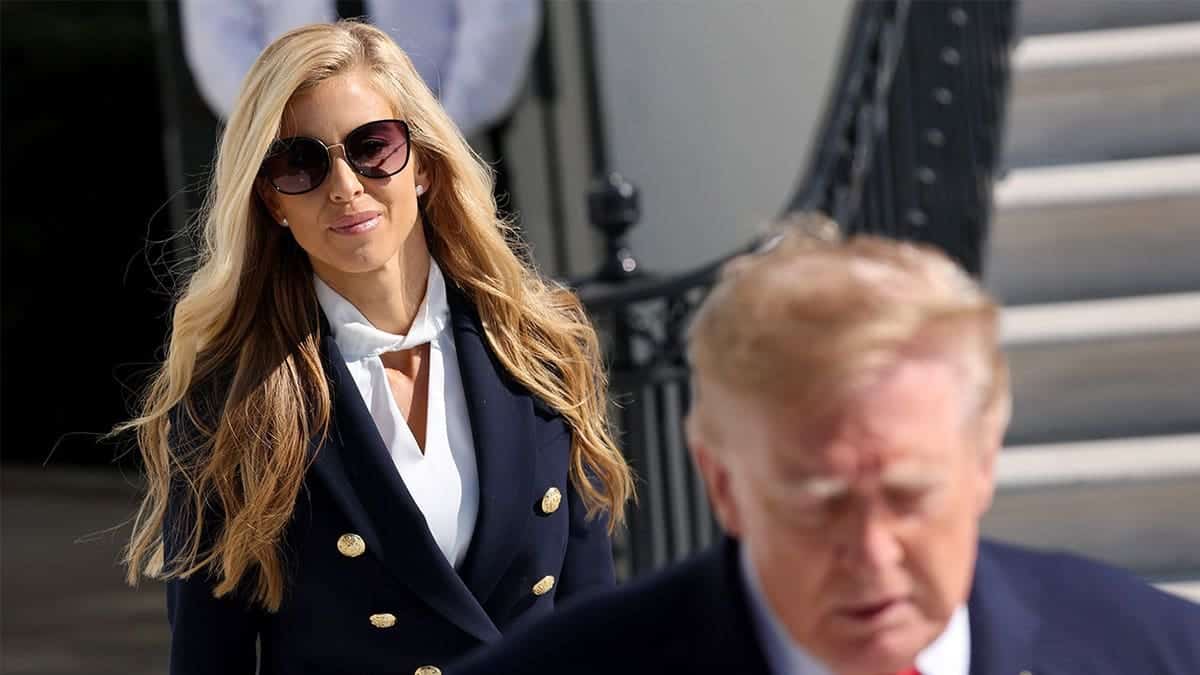 Katie Zacharia behind Donald Trump