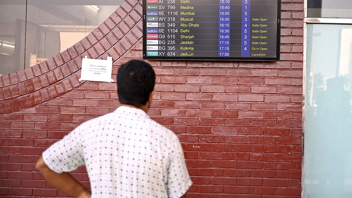 Man looking at airport table in Middle East
