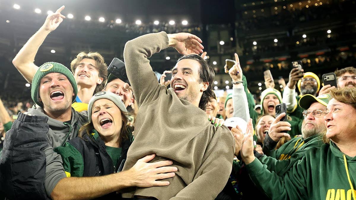 Milwaukee Brewers player participates in the Lambeau Leap at Lambeau Field
