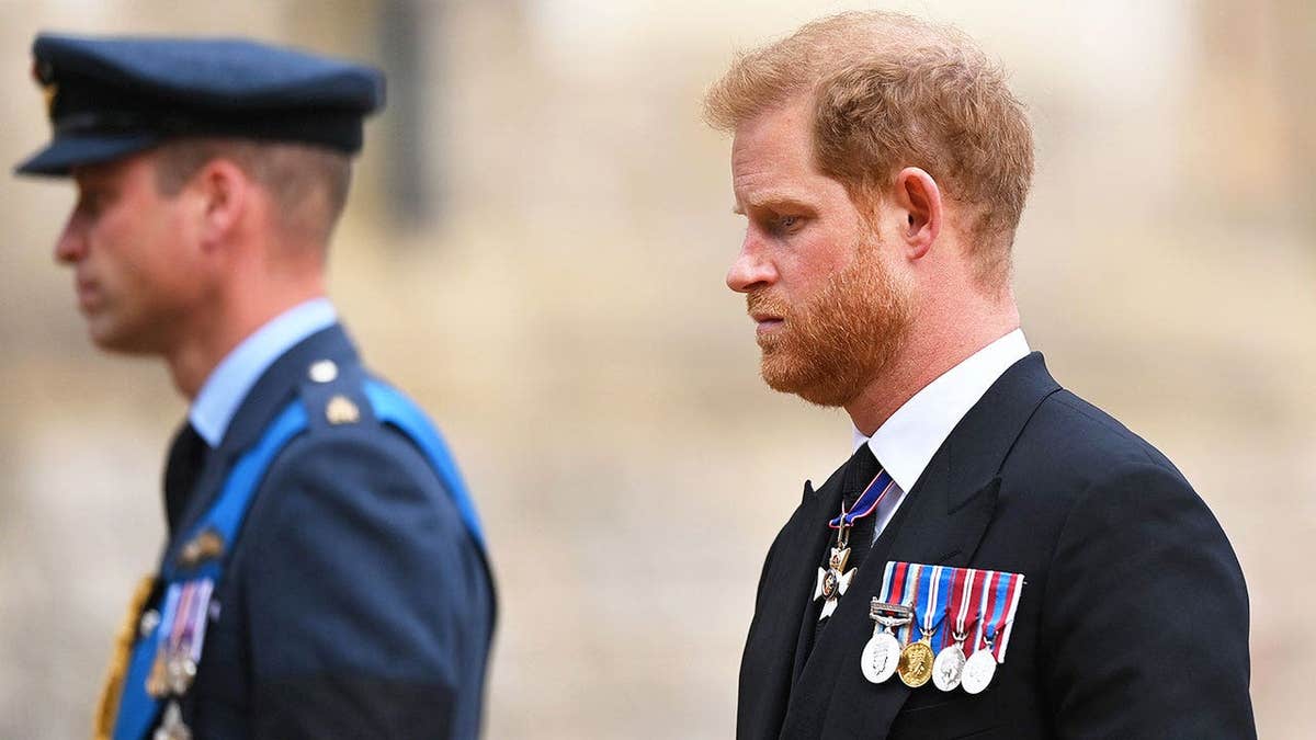 Prince William and Prince Harry looking somber in uniform as they march ahead.