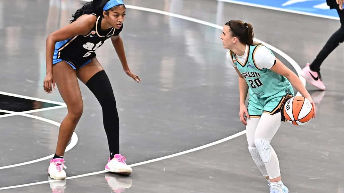 Sabrina Ionescu of the New York Liberty handles the ball against Angel Reese of the Atlanta Dream.