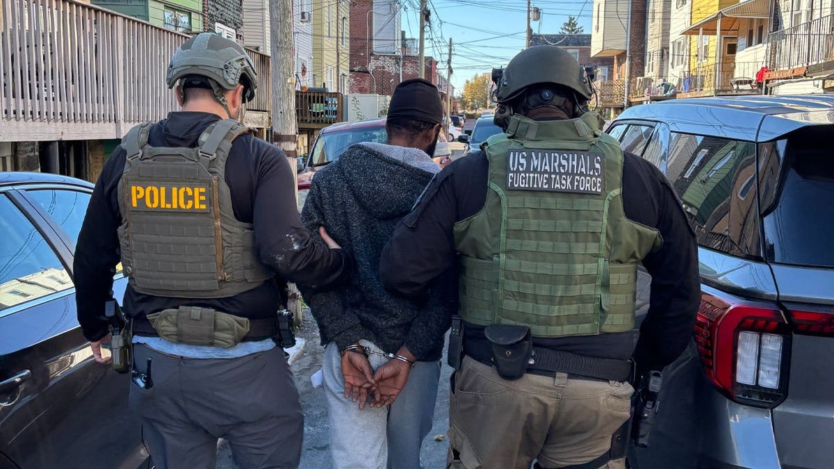 U.S. Marshals take Destino Jean-Louis into custody.