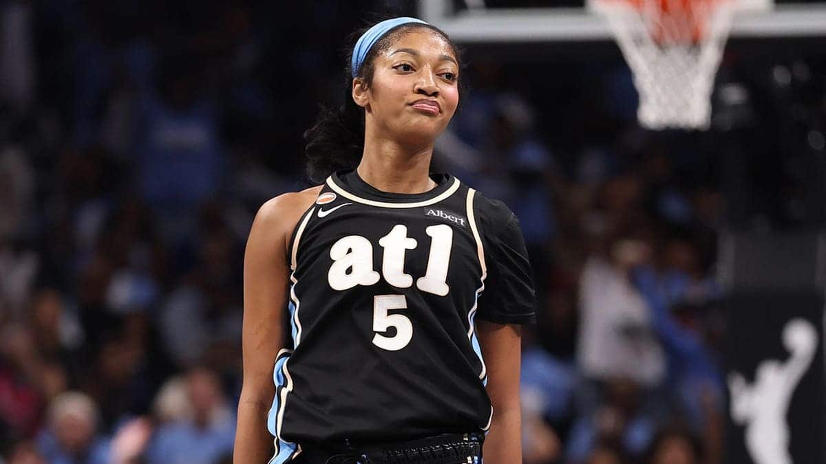 Angel Reese reacts after a made 3-pointer during WNBA Finals game.