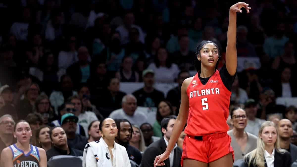 Angel Reese #5 reacts after making a basket during a WNBA playoff game.