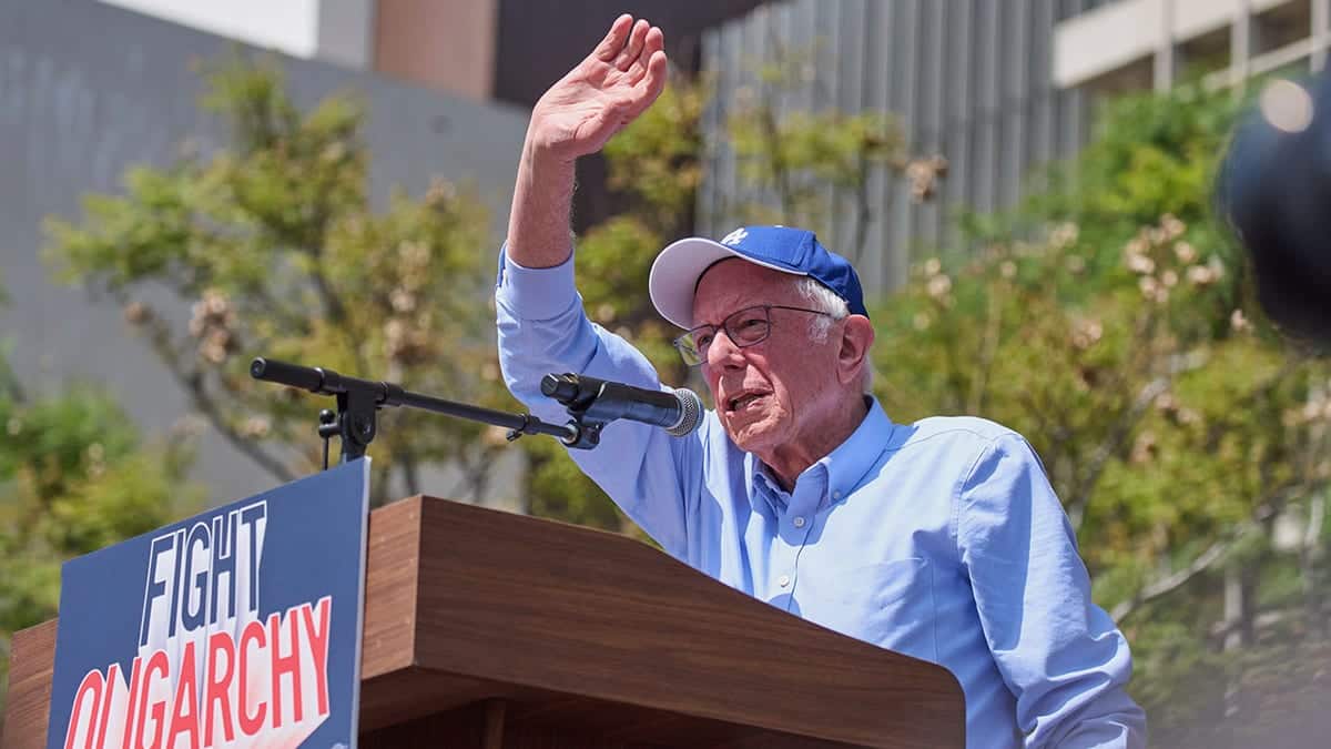 Bernie Sanders waves on stage at