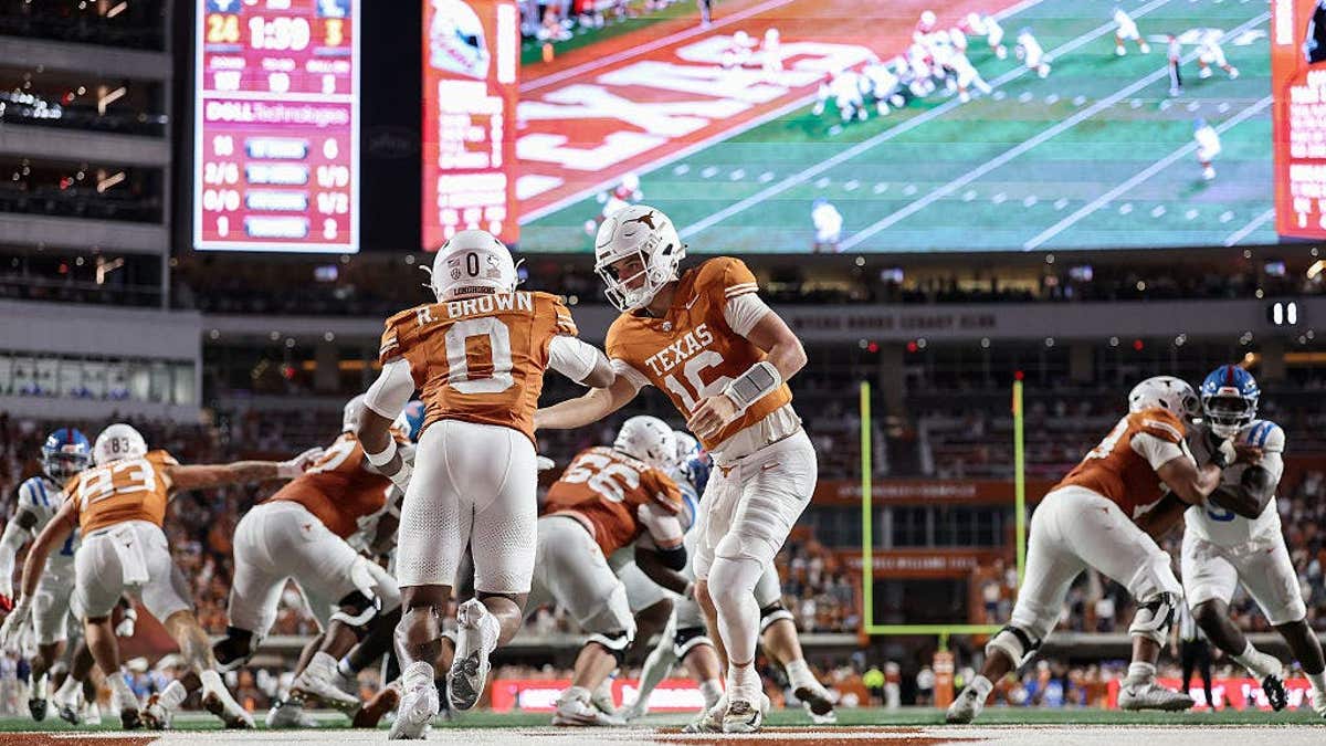 Arch Manning hands off to Raleek Brown during a Texas Longhorns football game.