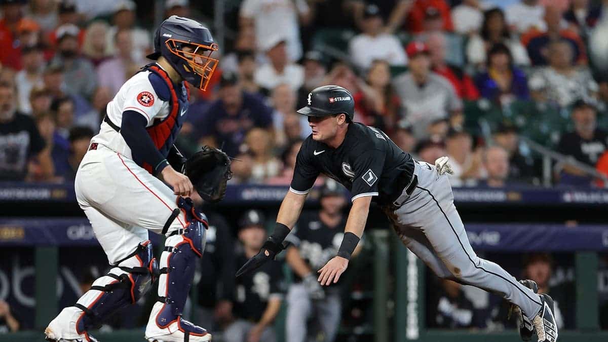 Sam Antonacci slides into home plate past Yainer Diaz during the first inning of the American League Wild Card Series.