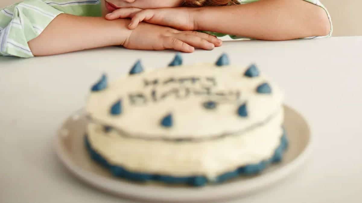 A photo of a child's hands and a birthday cake.