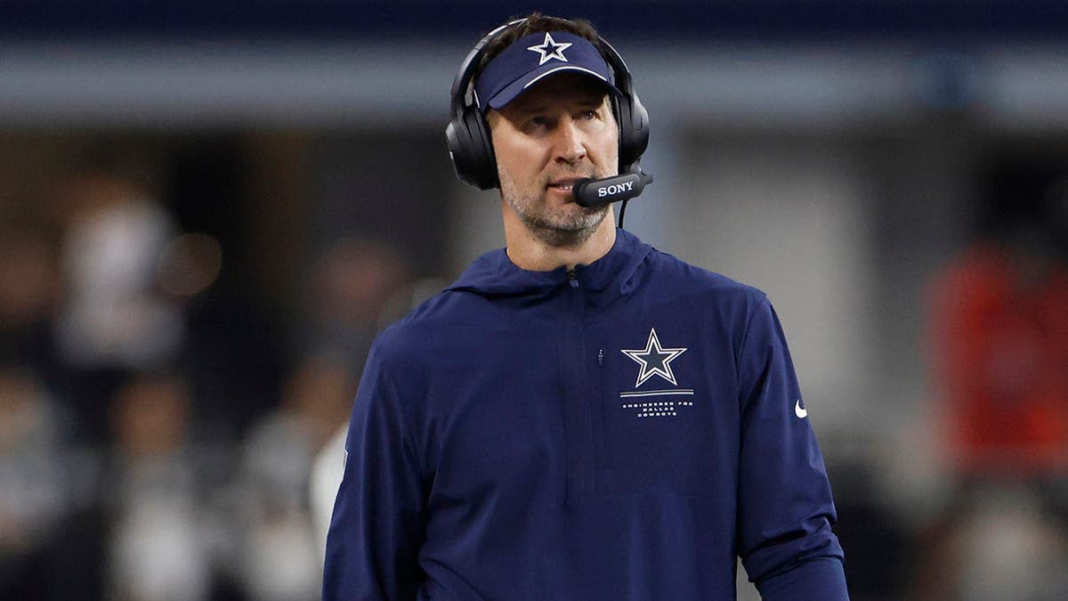 Brian Schottenheimer walks the sidelines during an NFL game at AT&T Stadium.