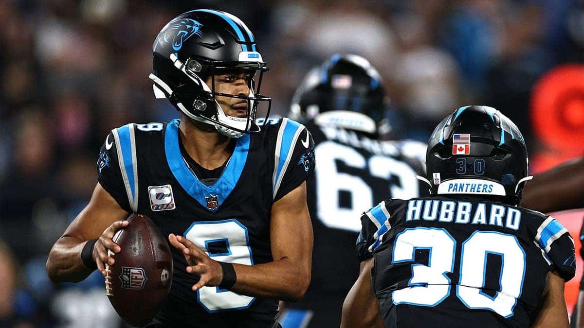 Bryce Young, wearing Carolina Panthers uniform number 9, looks to pass during an NFL game.