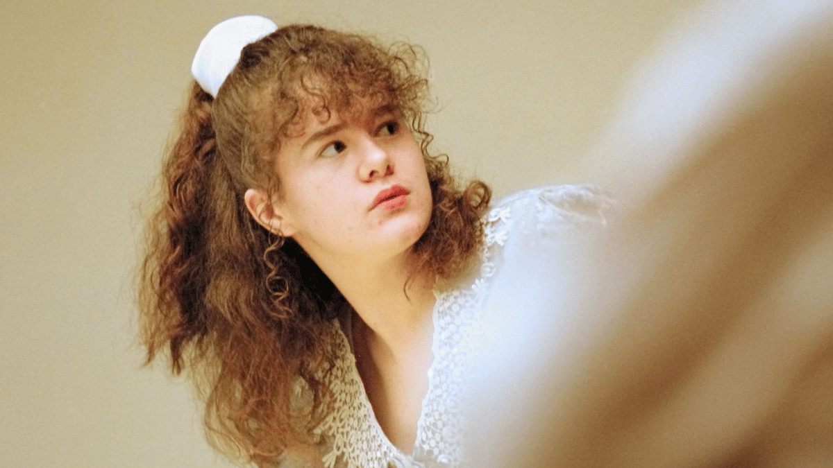 Christa Pike wearing white with curley red hair at trial in 1996