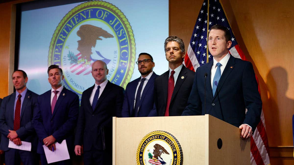 Assistant Attorney General Colin McDonald speaks at a DOJ fraud news conference in San Diego