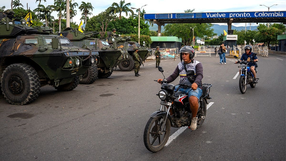 Motorcyclist speeding past police in North Santander, Colombia.