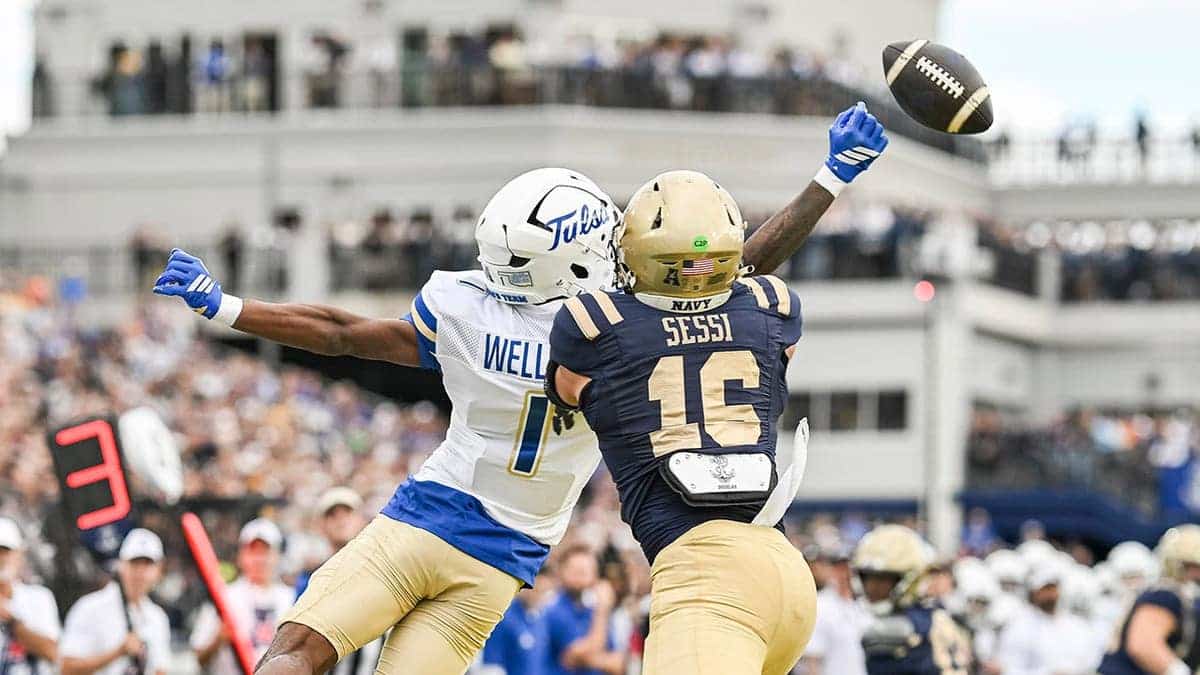 David Wells Jr. tips a pass in front of Giuseppe Sessi during a football game at Navy-Marine Corps Memorial Stadium.