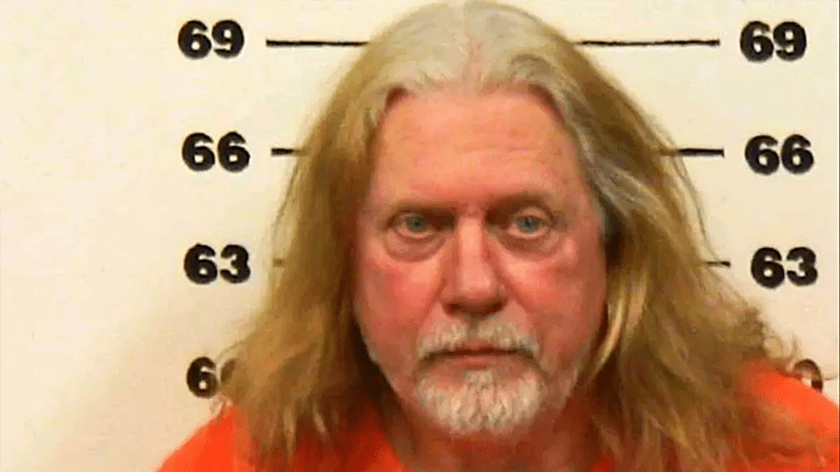 Don Wells mugshot, with long white hair and a short beard