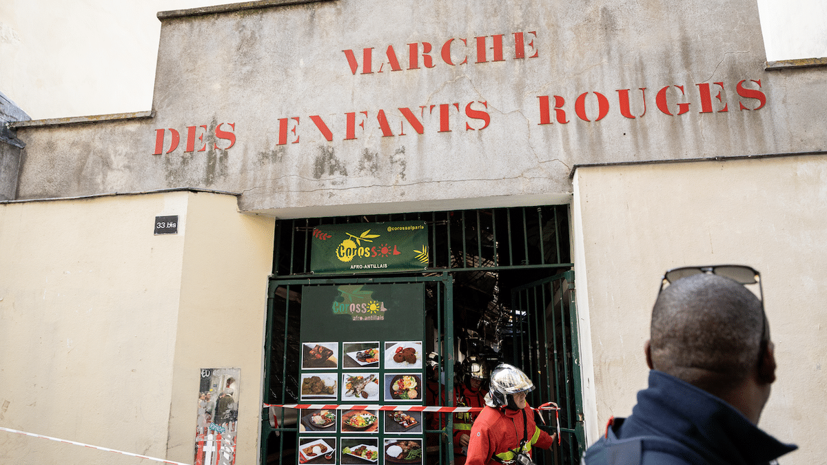 Firefighters work near the destroyed Enfants-Rouges market in the Marais neighborhood of Paris.