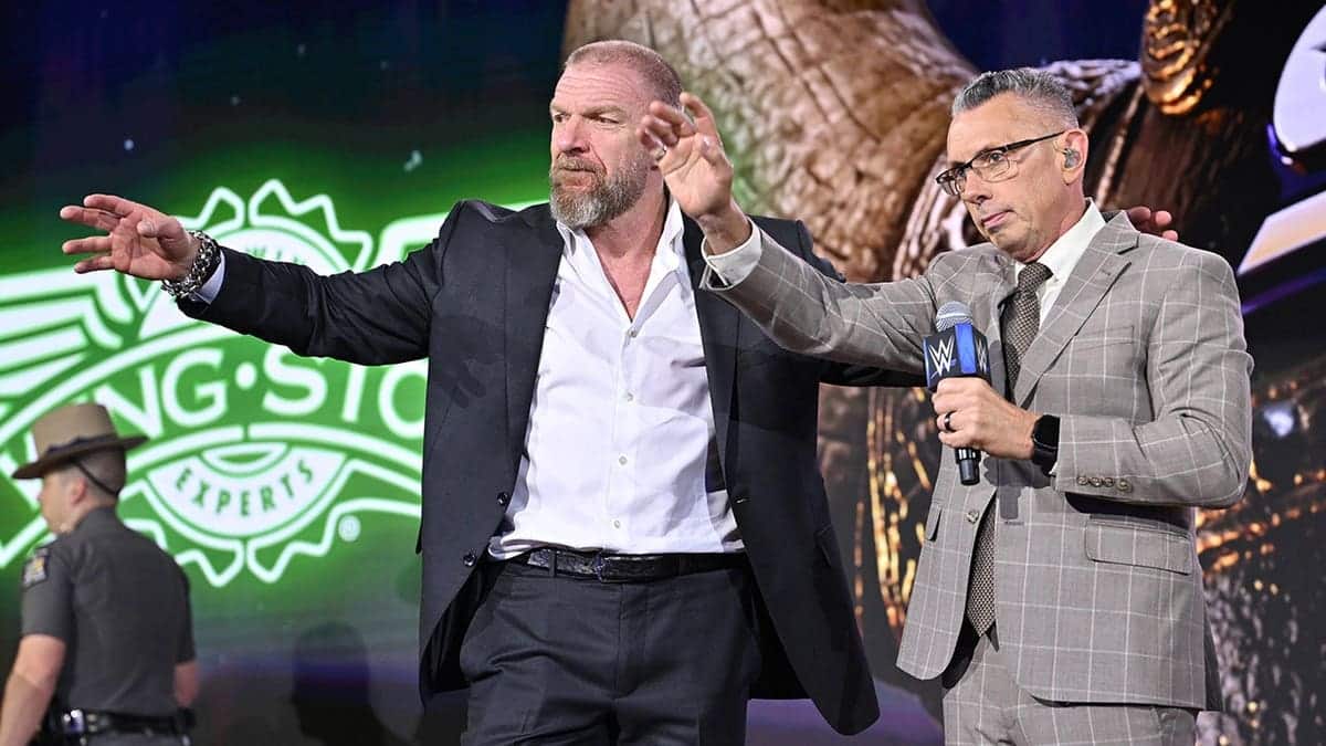 HHH and Michael Cole speak onstage during WWE SummerSlam Kickoff at Fanatics Fest NYC 2026.