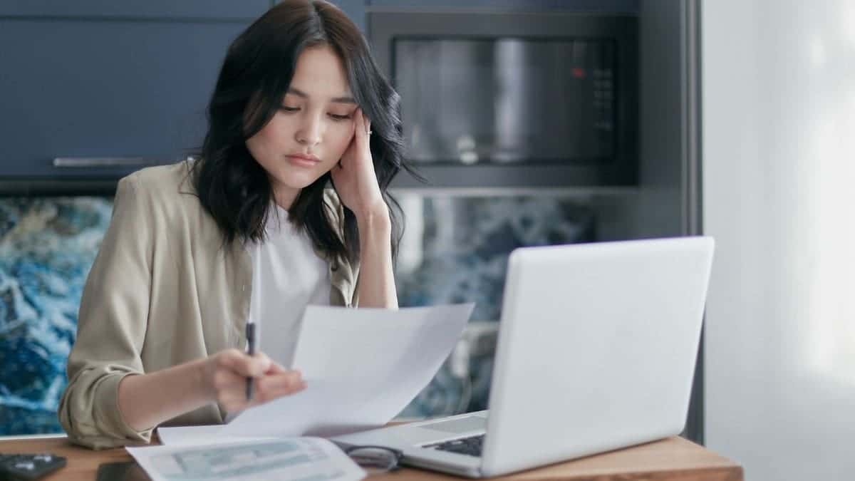 A woman looking at a bank statement