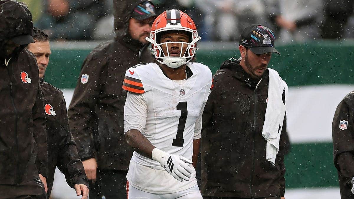 KC Concepcion of the Cleveland Browns walks off the field with medical staff during a game.