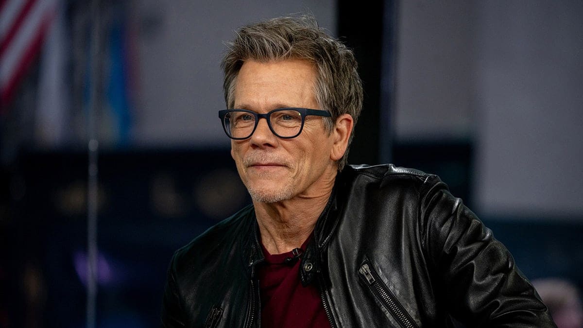 Close up of Kevin Bacon wearing glasses
