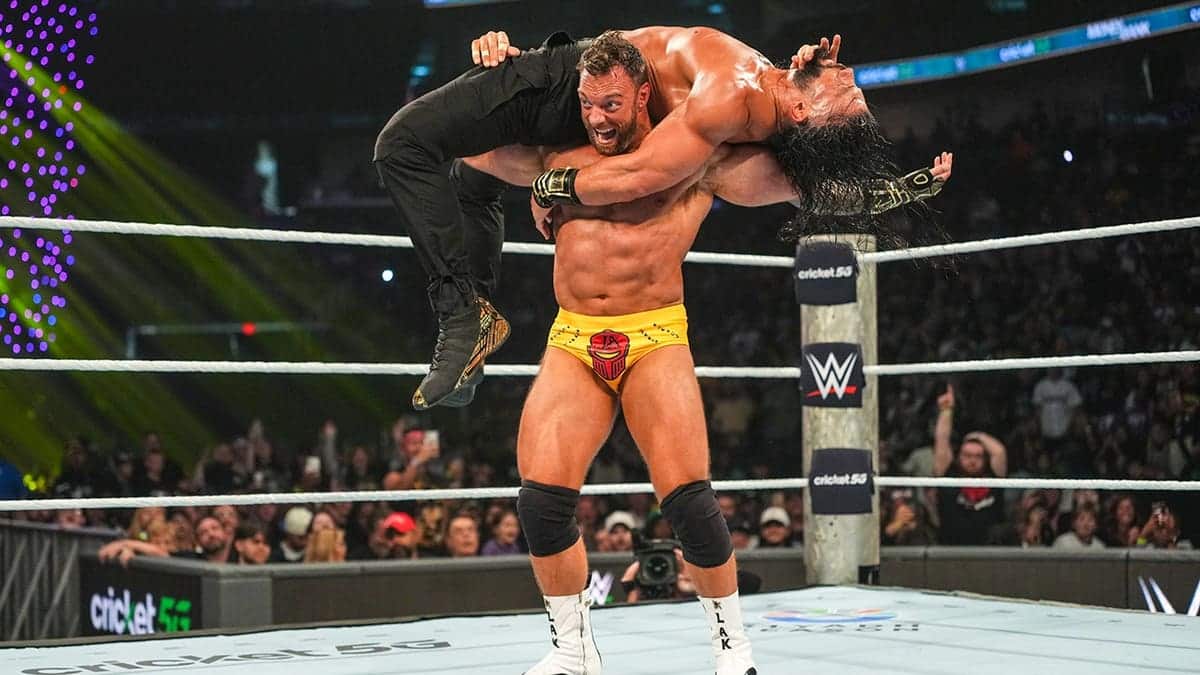 LA Knight in action against Roman Reigns during Money in the Bank wrestling match.
