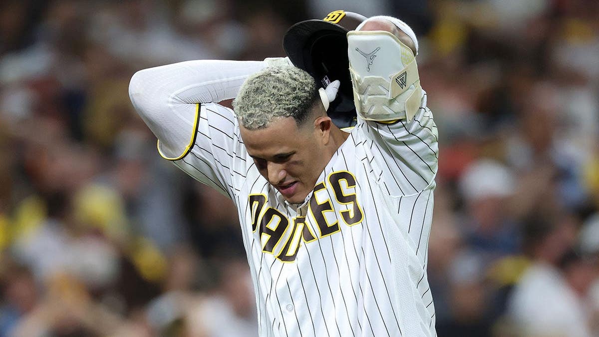 Manny Machado reacts after flying out during an MLB playoff game.