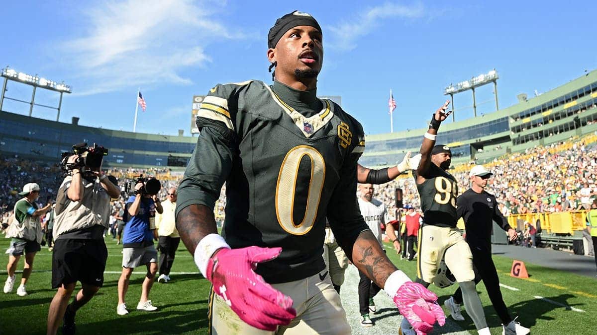 Matthew Golden celebrates on the field after a win at Lambeau Field.