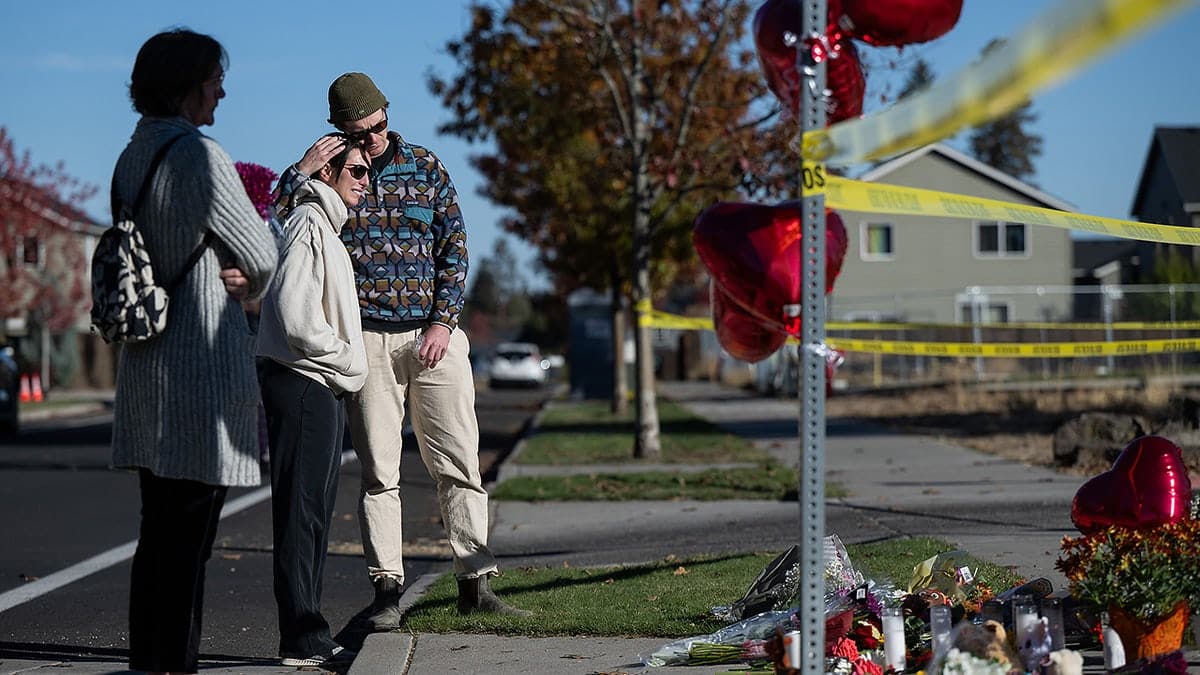 From right, Kyle Ketchum embraces Christina Edwards at a makeshift memorial outside Silver Rail Elementary in Bend, Ore., Friday, Oct. 16, 2026, a day after a deadly shooting.
