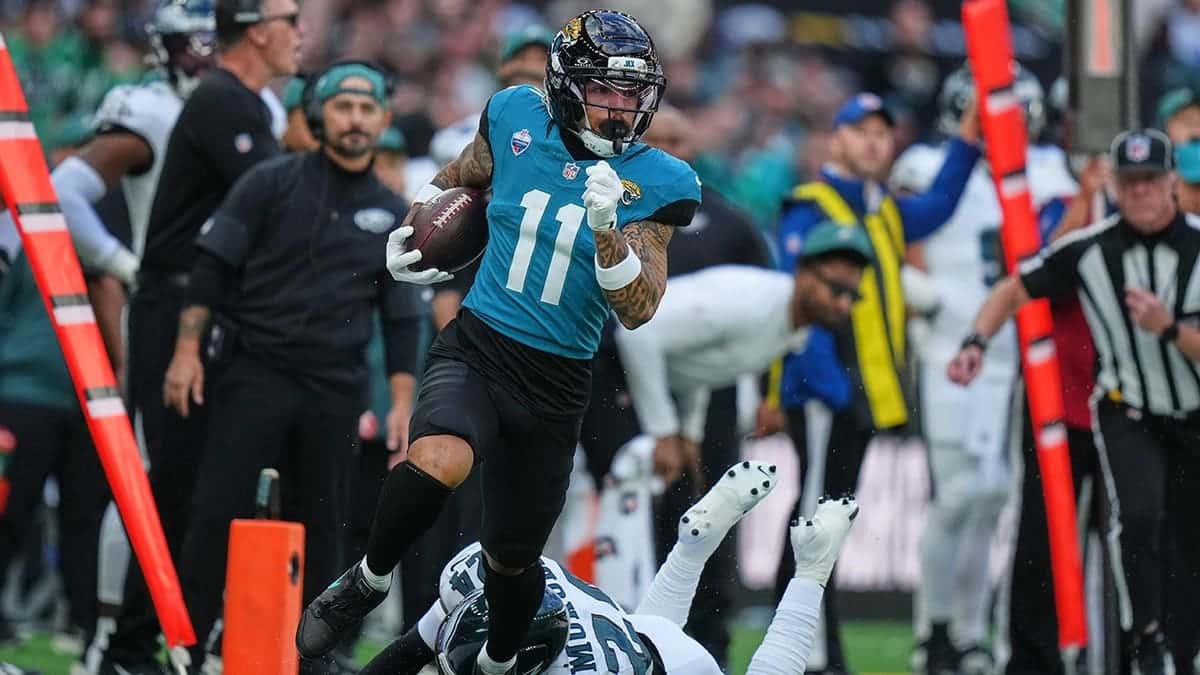 Parker Washington races through to score a touchdown during an NFL game in London.