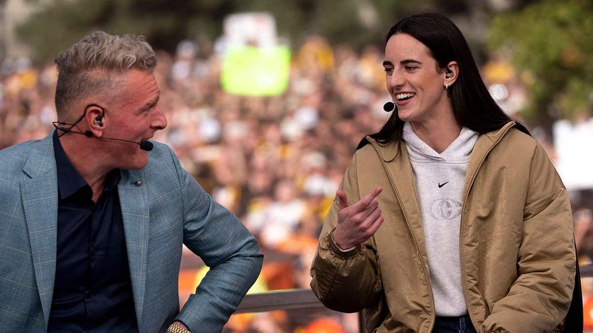 Pat McAfee listens to Caitlin Clark during a live ESPN College GameDay broadcast in downtown Iowa City, Iowa.
