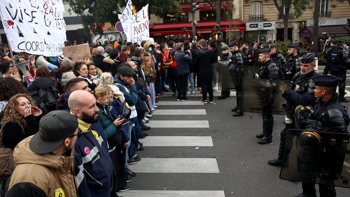Police officers block a street during a protest in Paris, France.