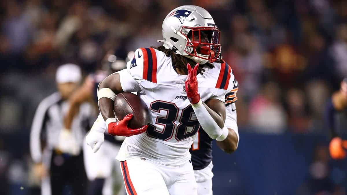Rhamondre Stevenson #38 runs with the ball to score a touchdown.