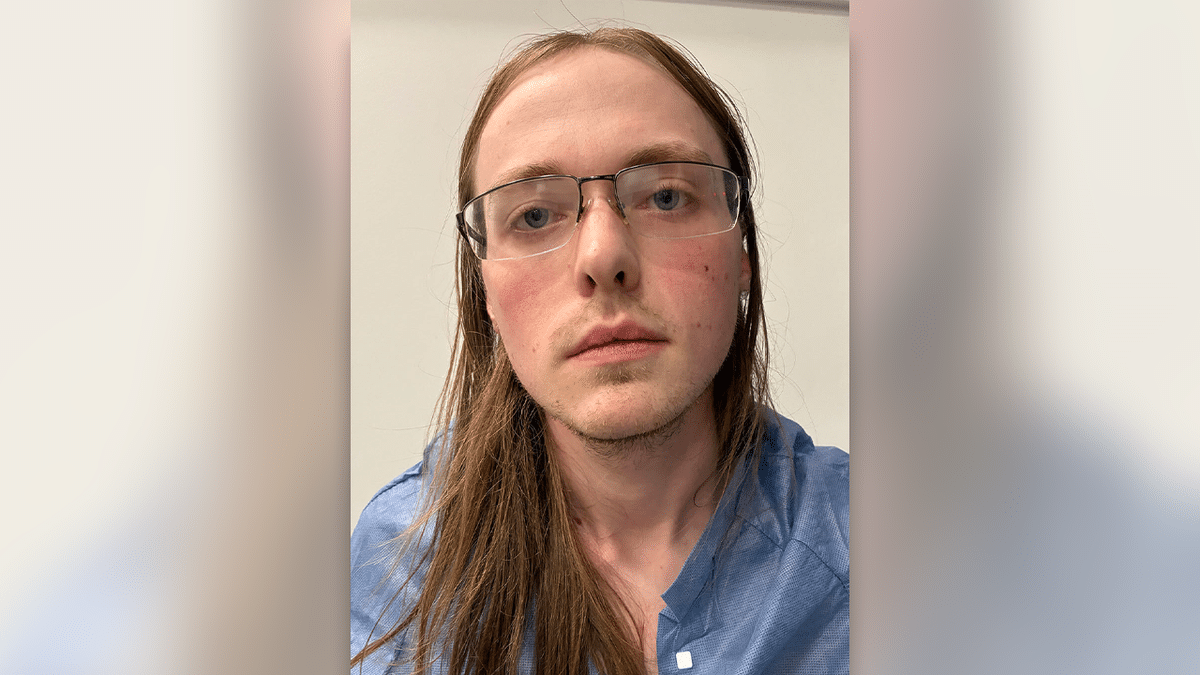 Ryan Hanafin long blond hair blue shirt and glasses in mugshot
