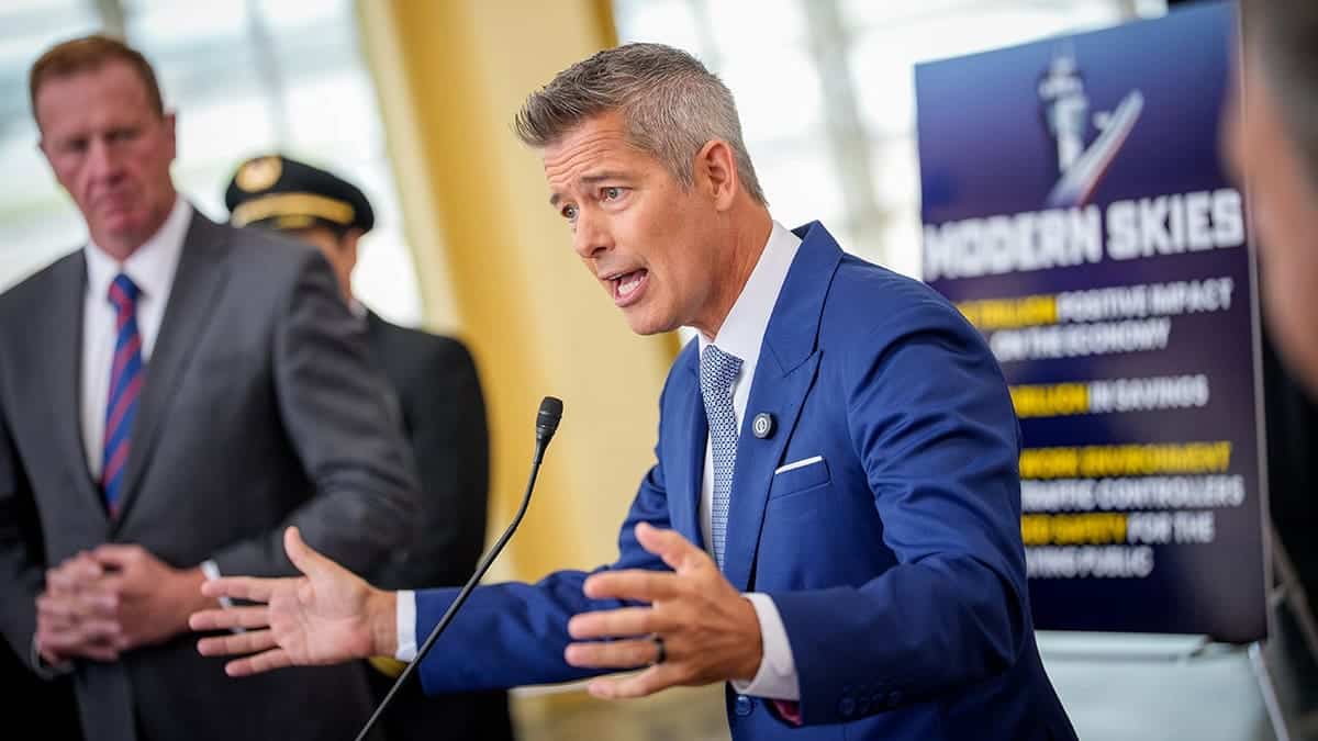 Transportation Secretary Sean Duffy speaks at a podium during a news conference at Ronald Reagan Washington National Airport.