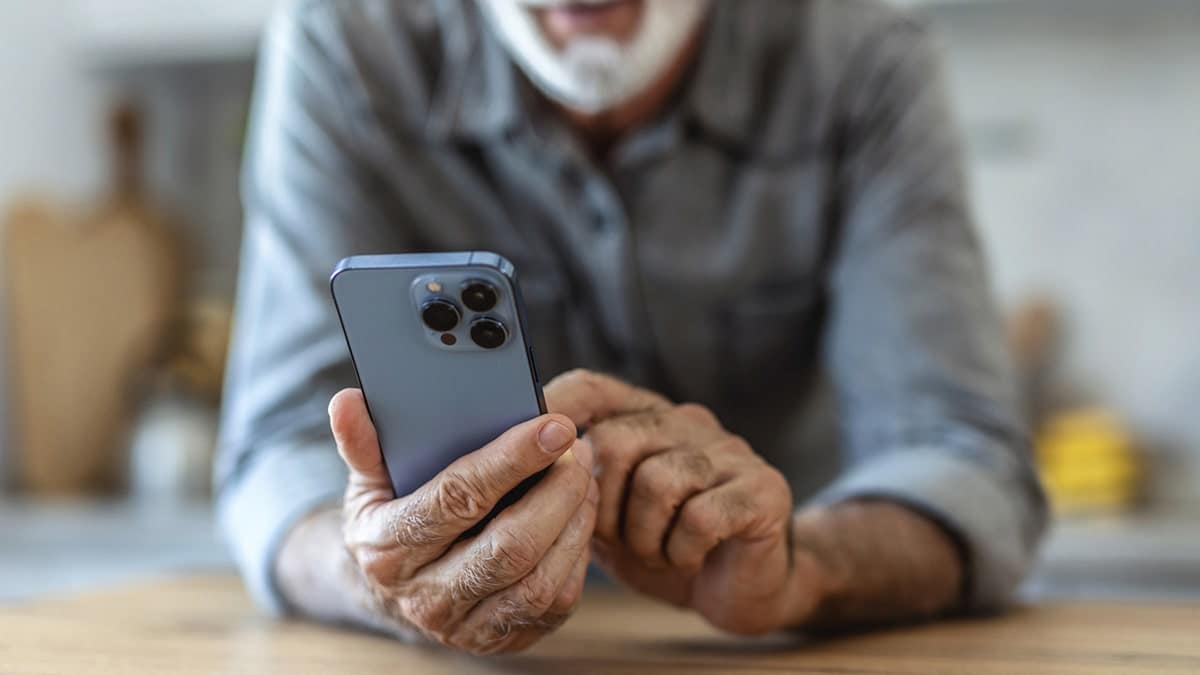 A person holds an IPhone.