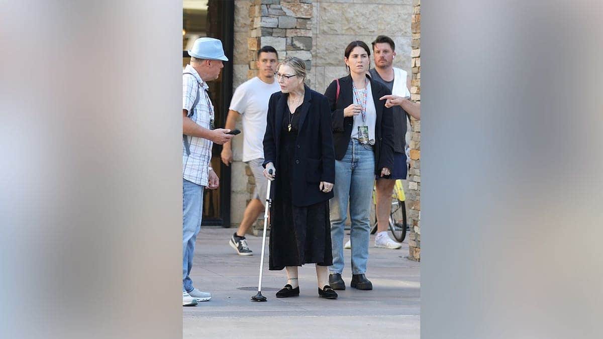 Tatum O'Neal walking around with a cane.