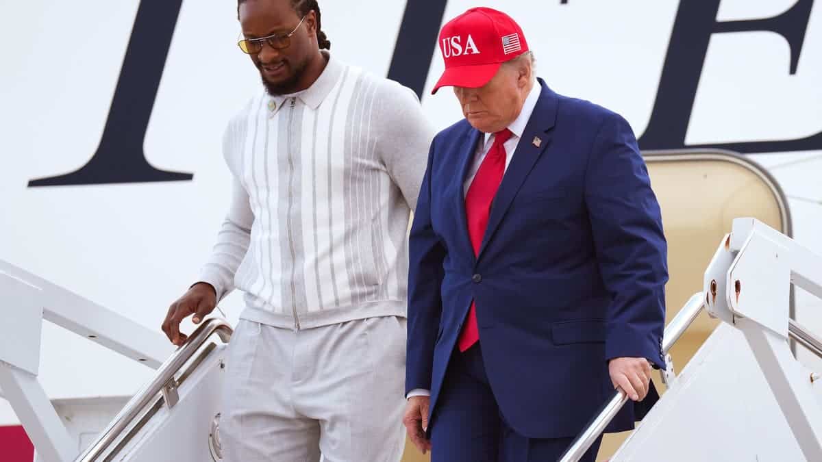 Donald Trump and Todd Gurley walk off Air Force One in Marietta, Georgia.