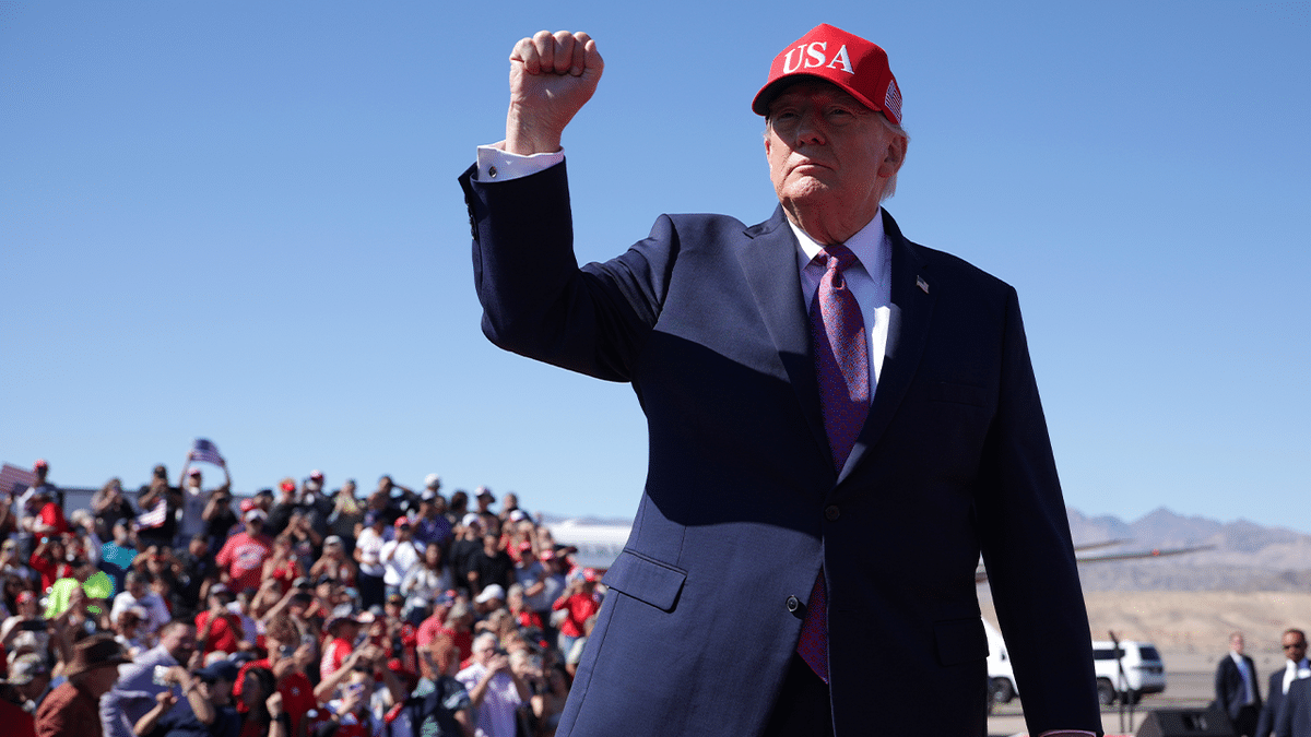President Donald Trump raises his fist in front of supporters at his Bullhead City, Arizona, rally