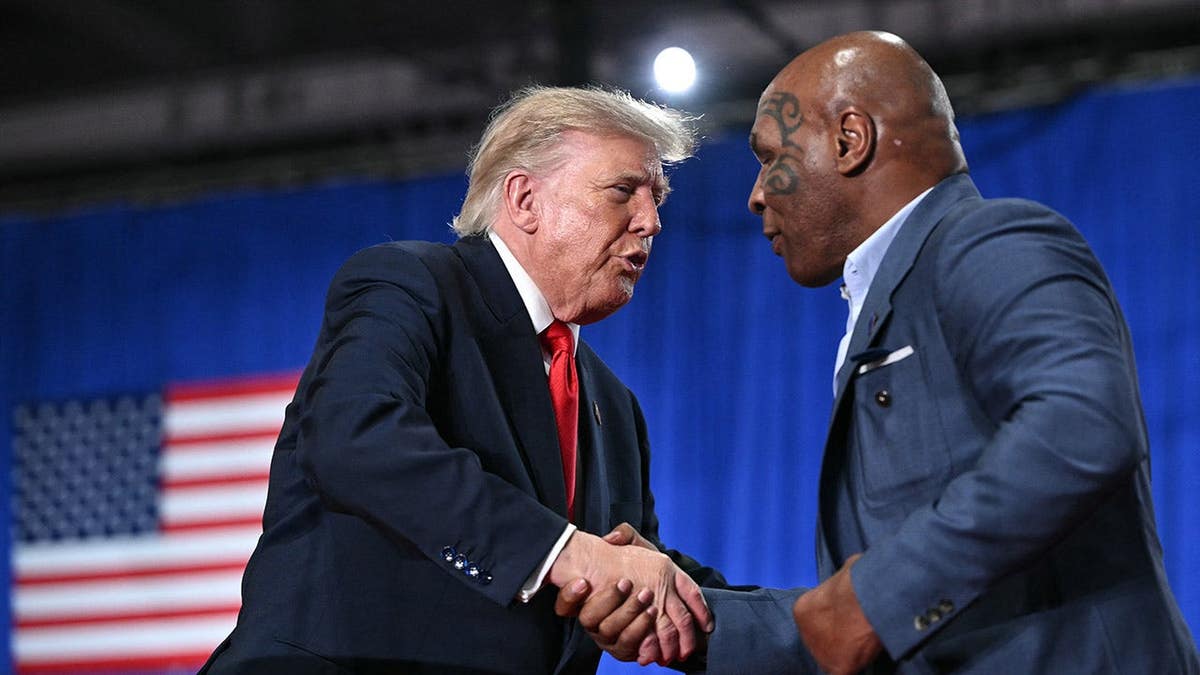 Donald Trump shakes hands with Mike Tyson at a campaign rally in Syracuse.