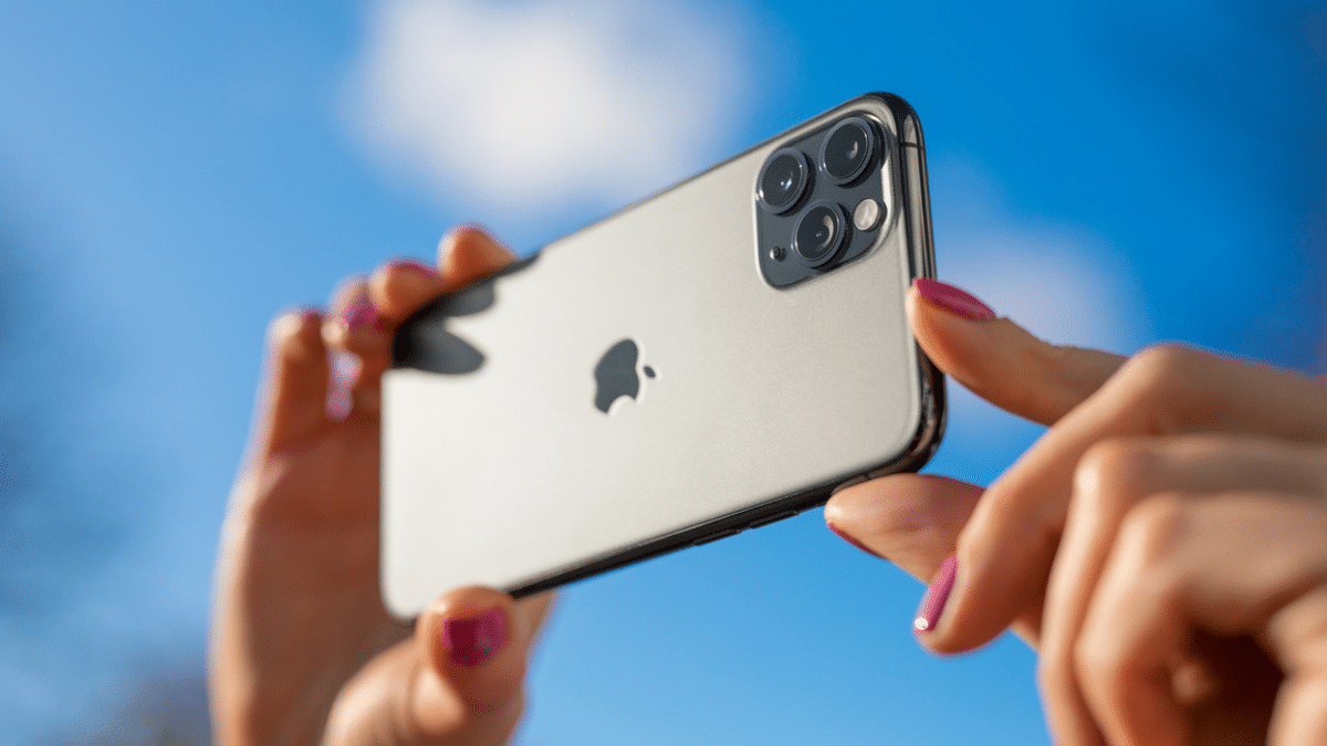 A person taking a picture with an iPhone