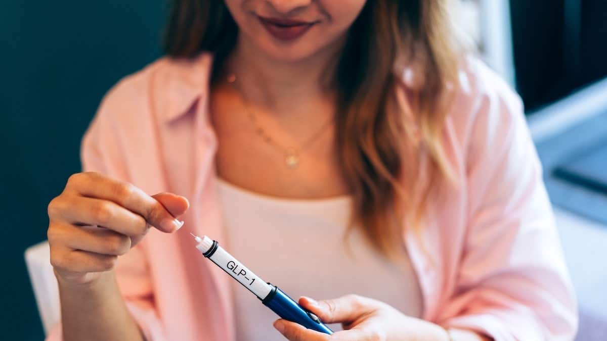 Woman holding GLP-1 medication