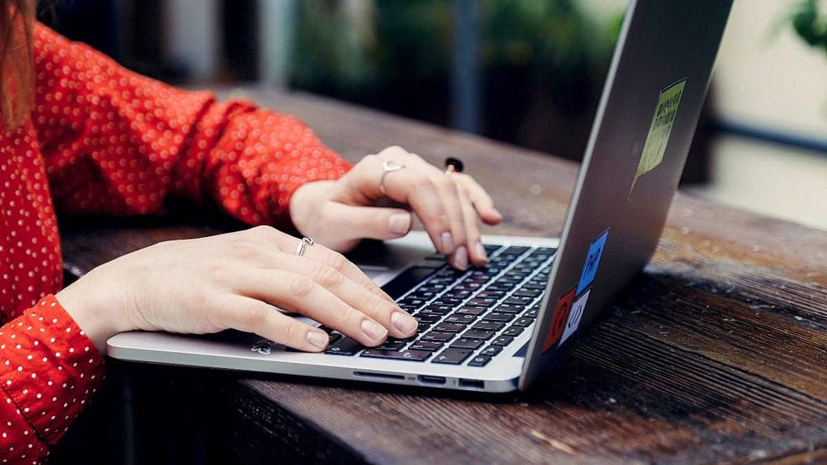 A woman typing on a computer.