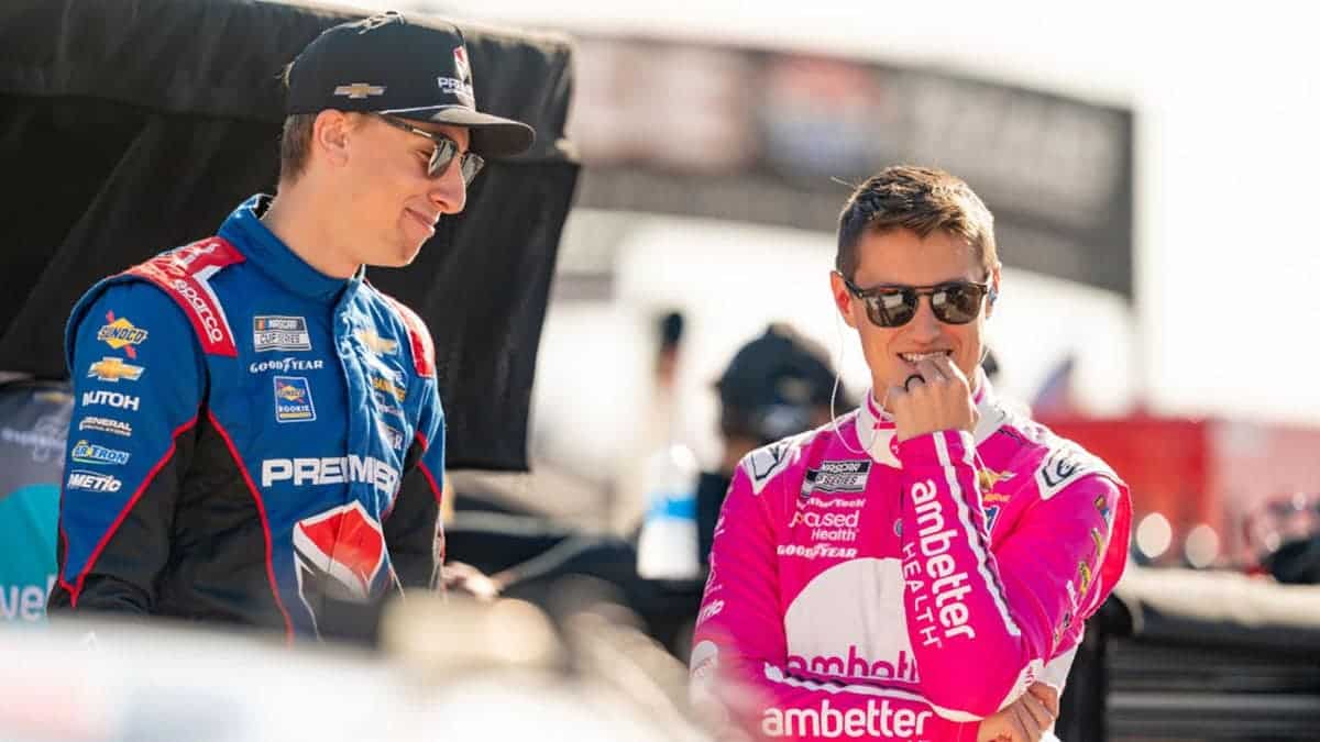 Zane Smith talks with Carson Hocevar before qualifying at Texas Motor Speedway.